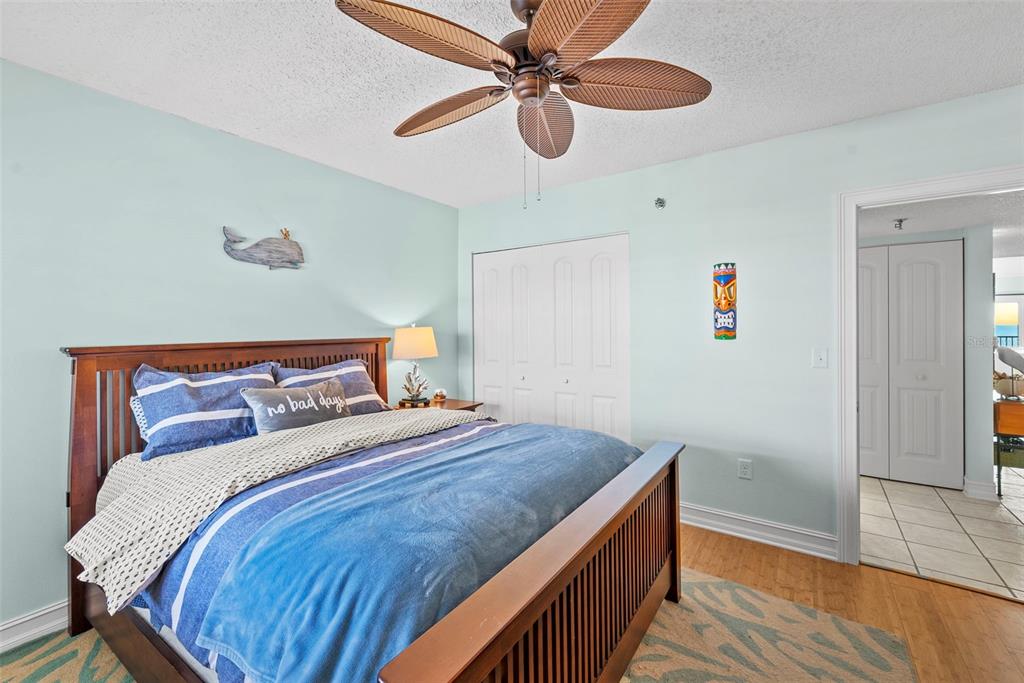 13650 Gulf Boulevard, Unit 604 Madeira Beach, FL 33708 - Photo 40 of 71 a bedroom with a bed and a ceiling fan