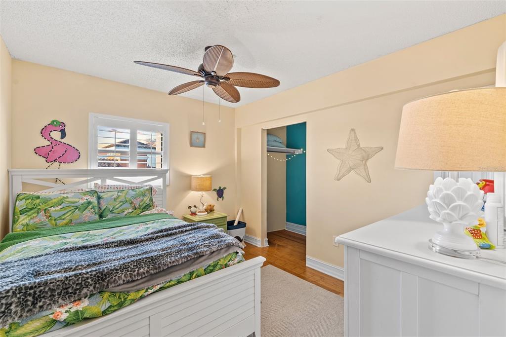 13650 Gulf Boulevard, Unit 604 Madeira Beach, FL 33708 - Photo 43 of 71 a bedroom with a bed and furniture