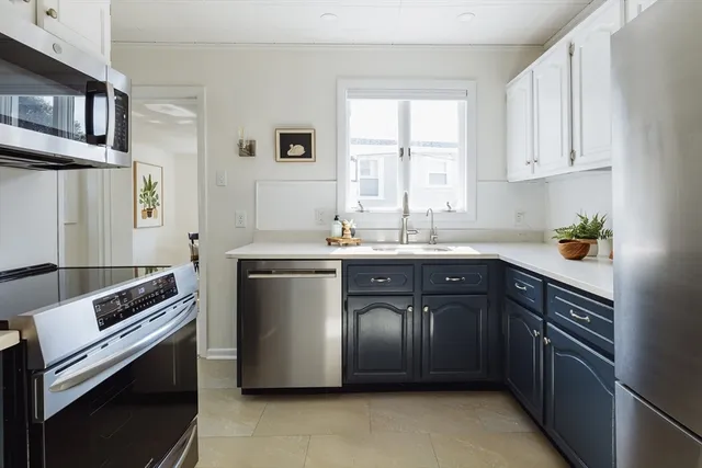 a kitchen with a sink stove and cabinets