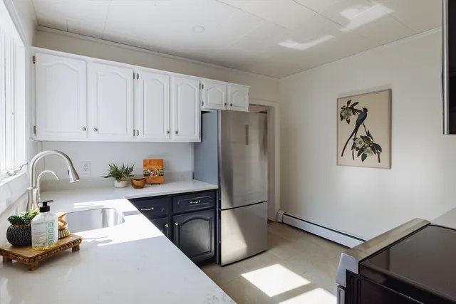 a kitchen with a refrigerator and a sink