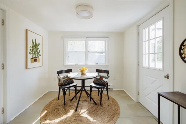 a view of a dining room with furniture and window