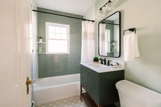 a bathroom with a sink mirror toilet and bathtub