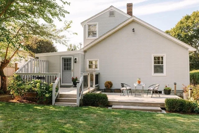 a front view of a house with a garden and plants