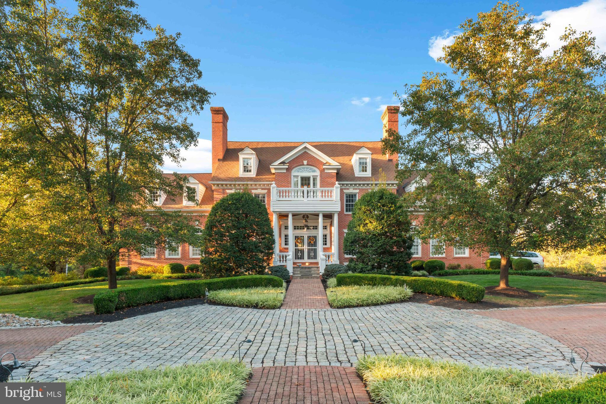 a view of house with a yard and large trees