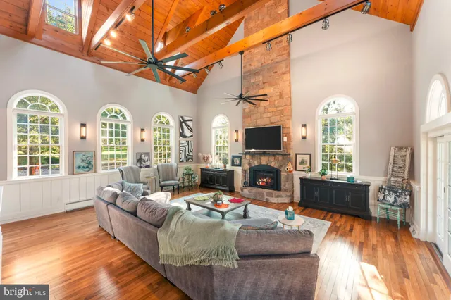 a dining room with furniture a chandelier and wooden floor