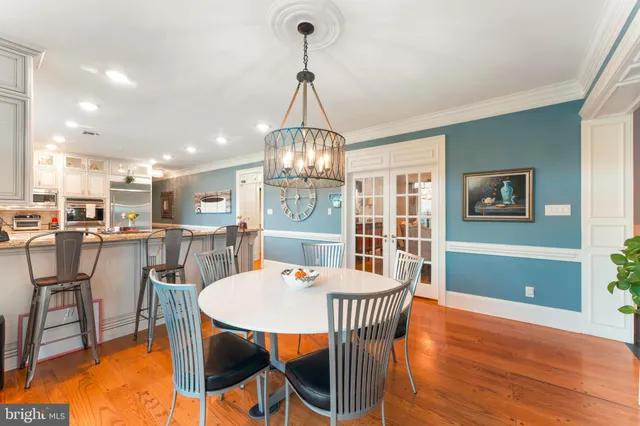 a living room with a balcony furniture and a flat screen tv