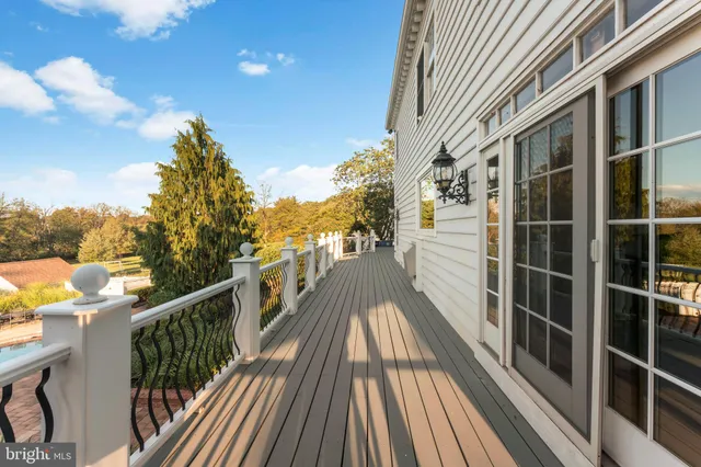 a bathroom with a granite countertop sink a toilet a mirror and shower
