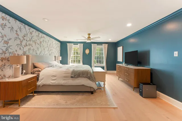 a bedroom with a bed and a chandelier