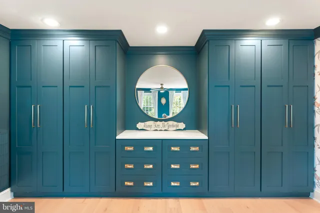 a living room with furniture stairs and a wooden floor