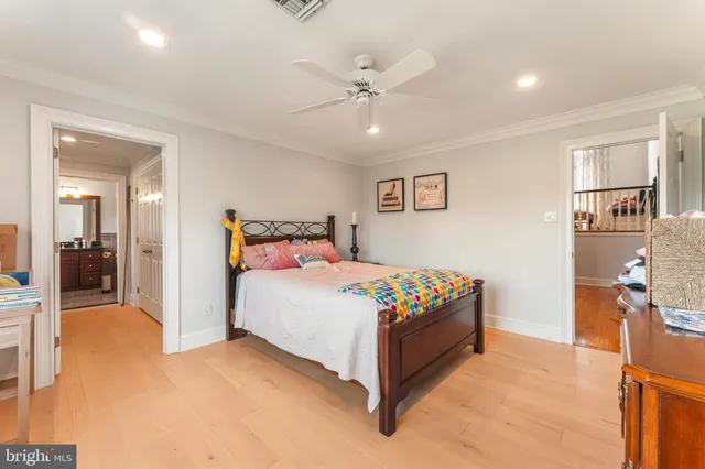 a dining hall with stainless steel appliances lots of white furniture a table and chairs