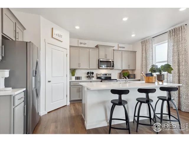 a kitchen with appliances cabinets and a counter top space