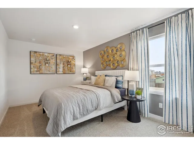 a bedroom with a bed and a large mirror