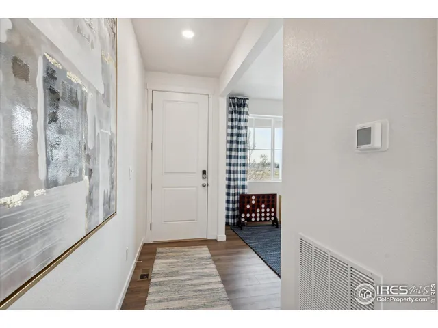 a view of an entryway with wooden floor