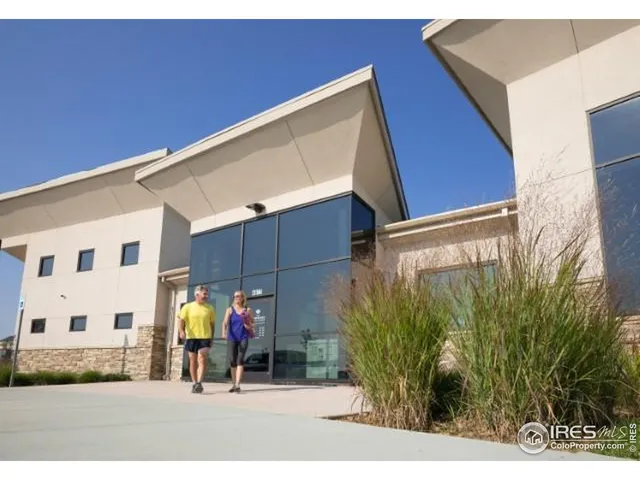 a view of a street with potted plants