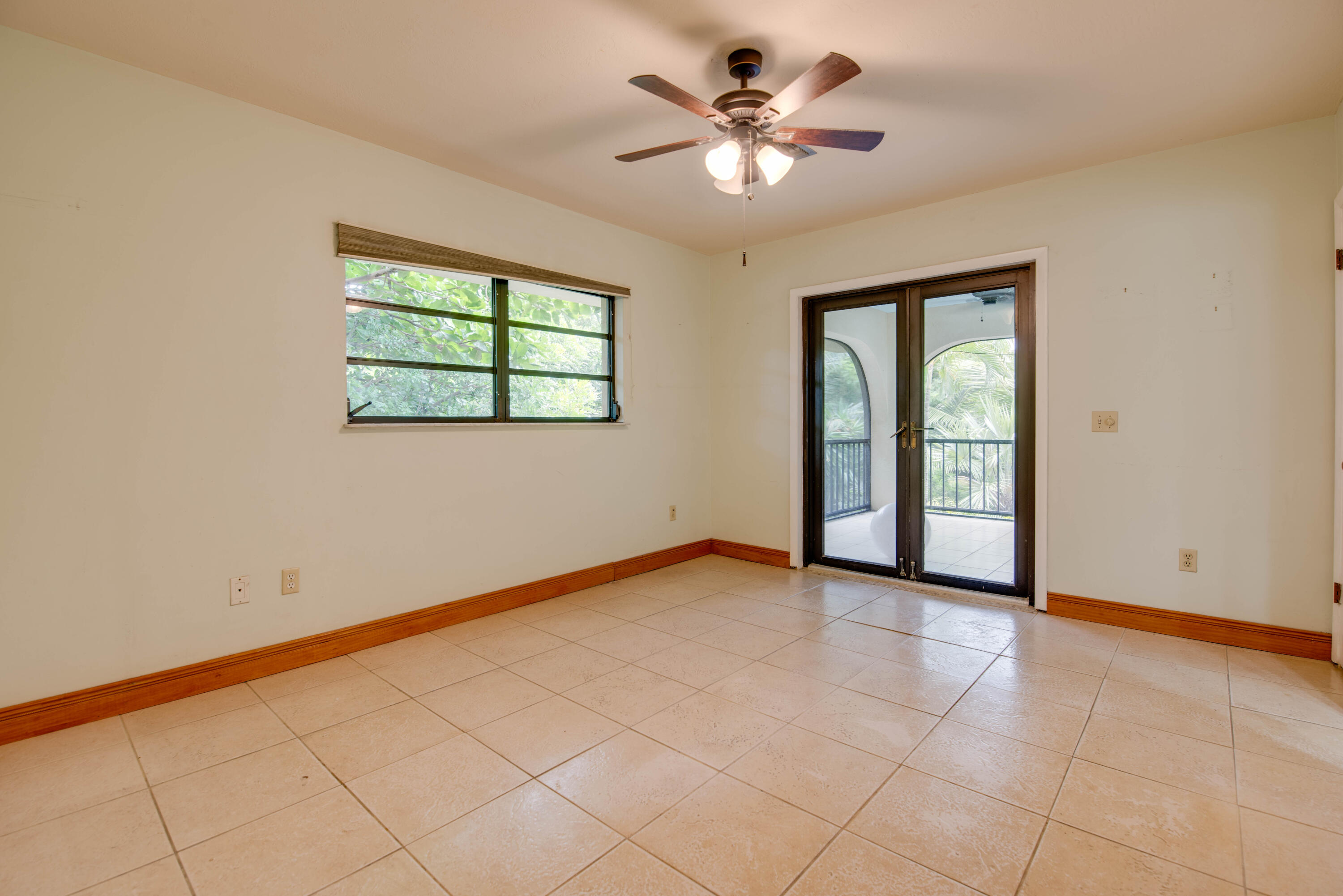 29850 Journeys End Road Big Pine Key, FL 33043 - Photo 11 of 32 an empty room with chandelier fan and windows
