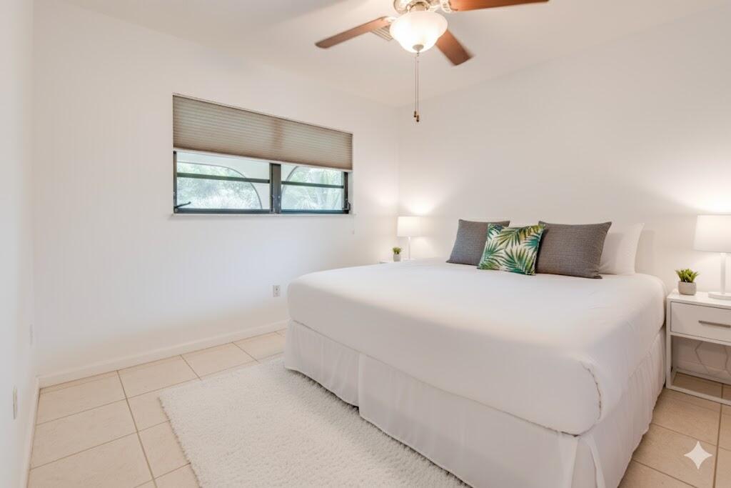 29850 Journeys End Road Big Pine Key, FL 33043 - Photo 19 of 32 a bedroom with a bed and a painting on the wall