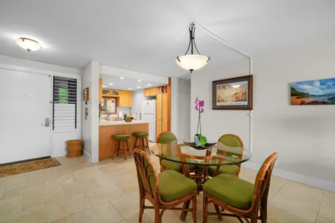 a view of a dining room with furniture and a chandelier