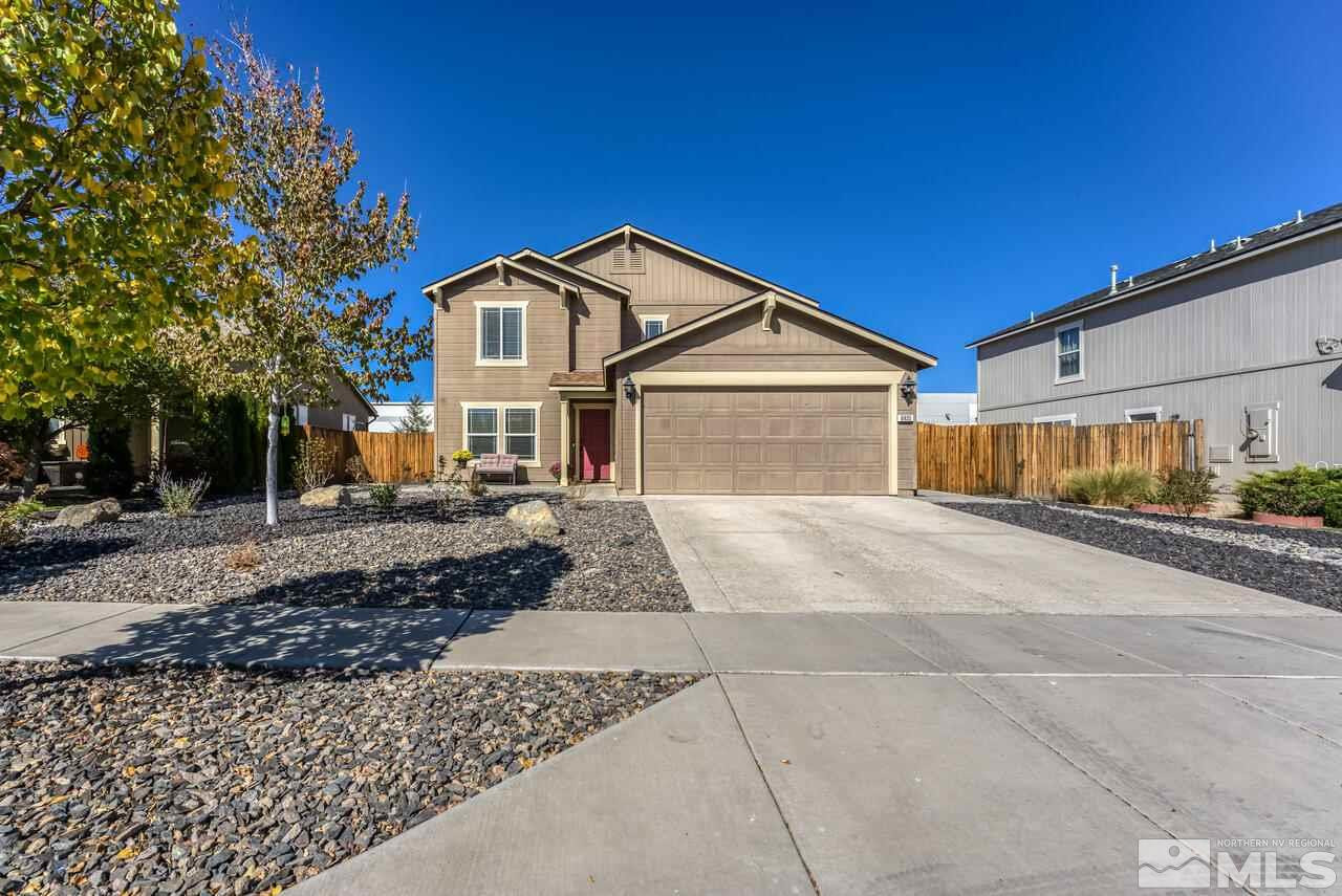 8935 Convair Way Reno, NV 89506 - Photo 1 of 39 a front view of a house with a yard and garage