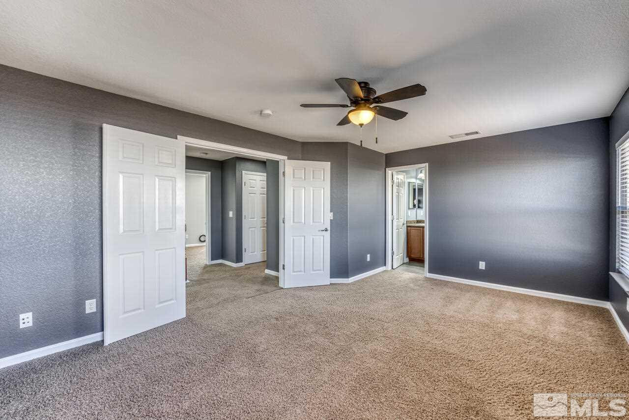 8935 Convair Way Reno, NV 89506 - Photo 26 of 39 a view of a big room with chandelier fan and windows