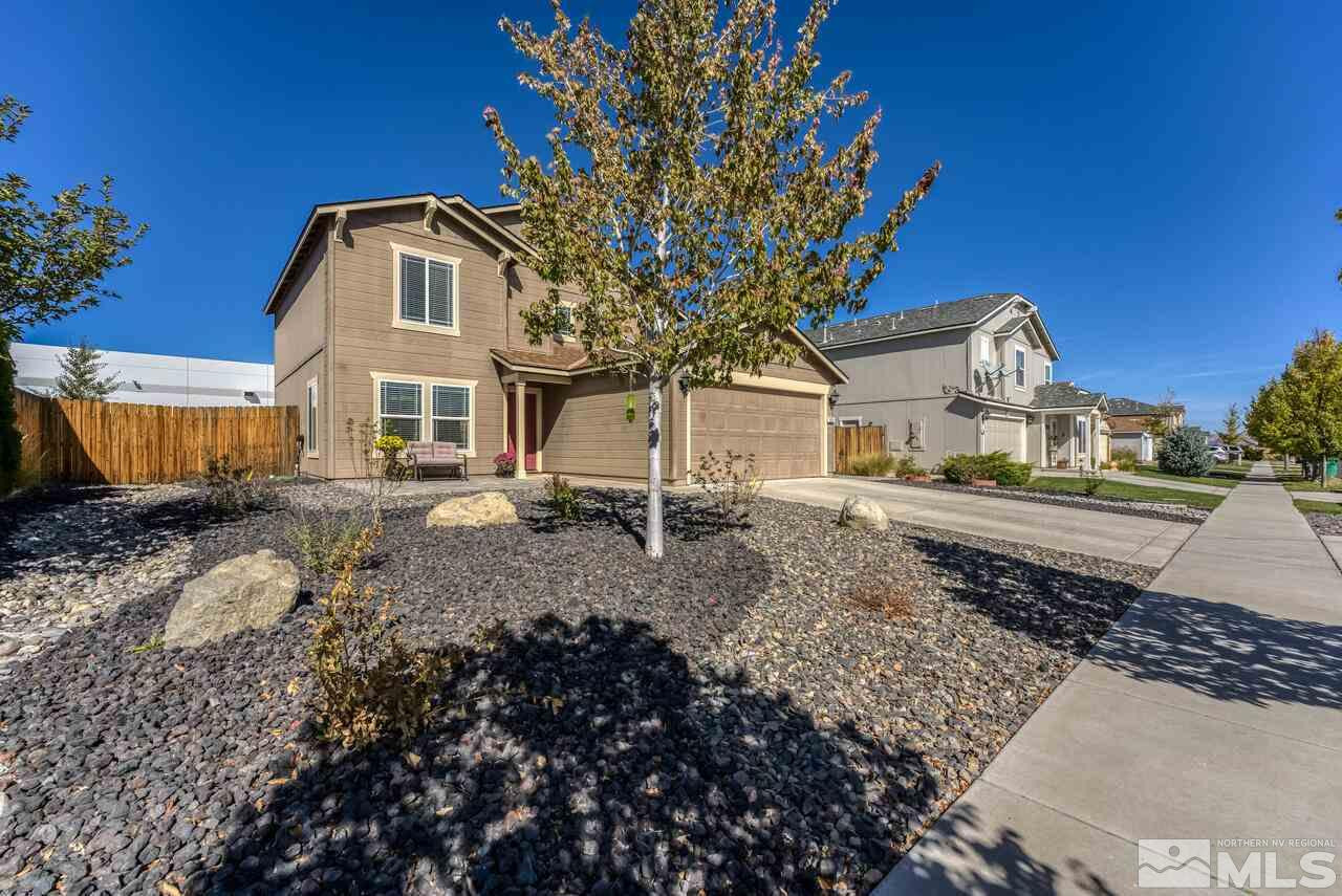 8935 Convair Way Reno, NV 89506 - Photo 3 of 39 a front view of a house with a yard