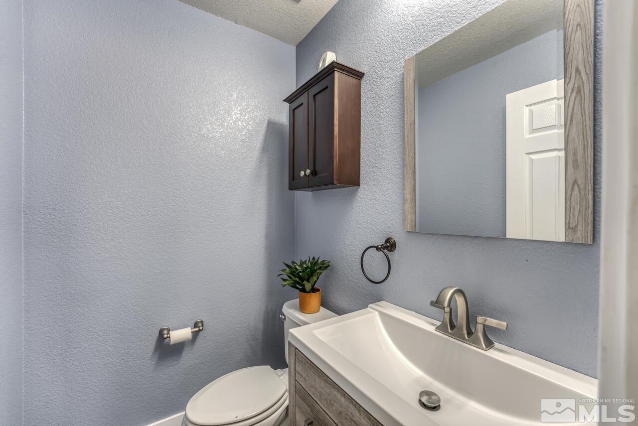 8935 Convair Way Reno, NV 89506 - Photo 33 of 39 a bathroom with a sink toilet and mirror