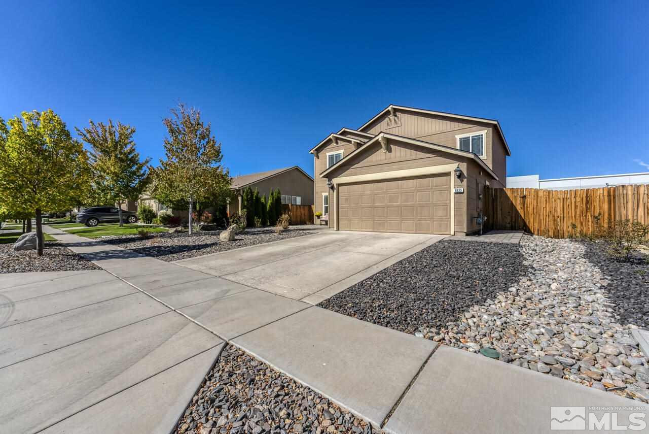 8935 Convair Way Reno, NV 89506 - Photo 4 of 39 a front view of a house with a yard
