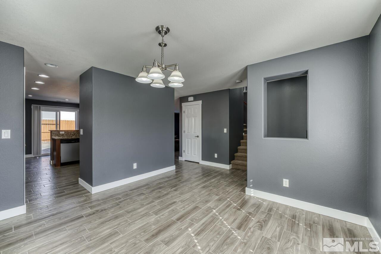 8935 Convair Way Reno, NV 89506 - Photo 8 of 39 wooden floor in an empty room with a mirror