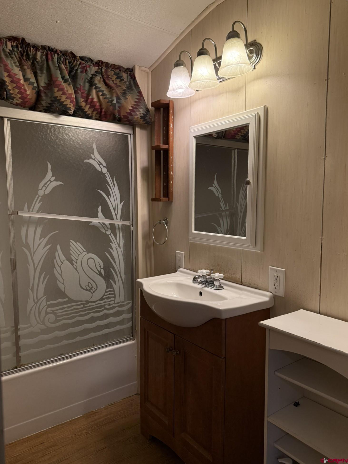 311 West 3rd Street Delta, CO 81416 - Photo 16 of 24 a bathroom with a sink and a mirror