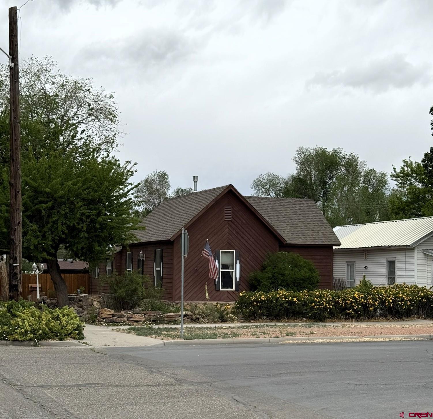 311 West 3rd Street Delta, CO 81416 - Photo 20 of 24 a front view of a house with a yard and potted plants