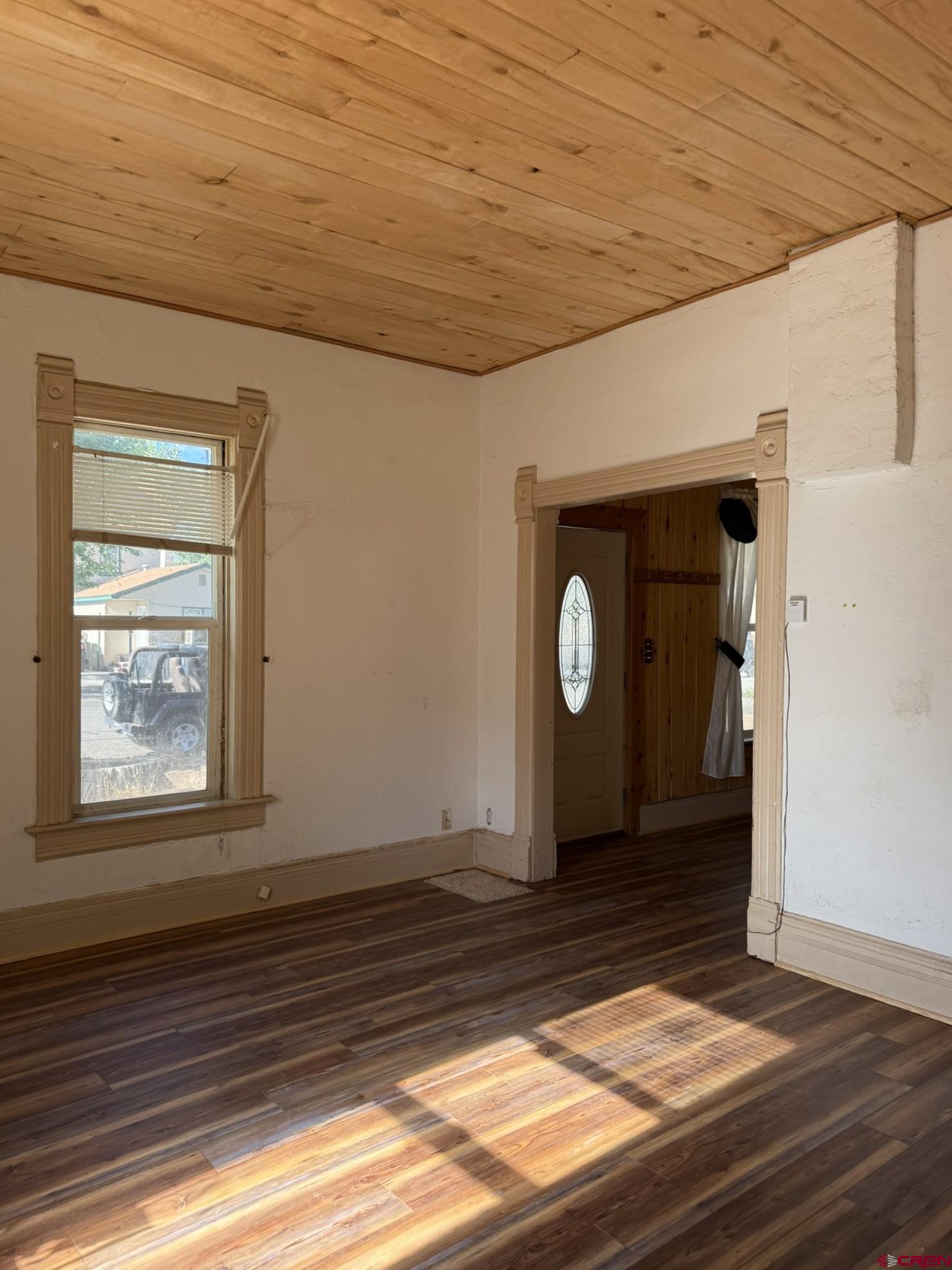 311 West 3rd Street Delta, CO 81416 - Photo 8 of 24 a view of an empty room with wooden floor and a window