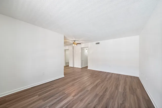 a view of a room with wooden floor