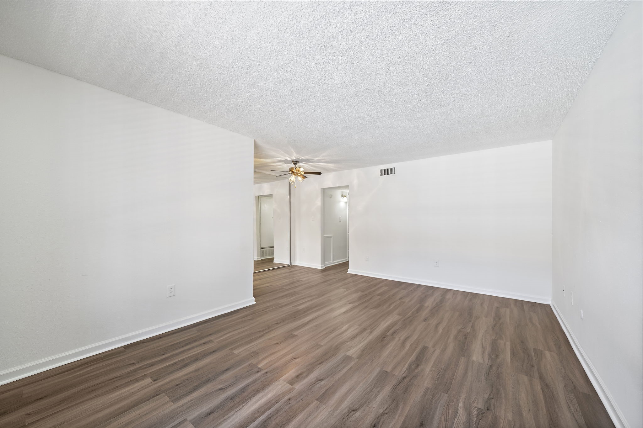 a view of a room with wooden floor