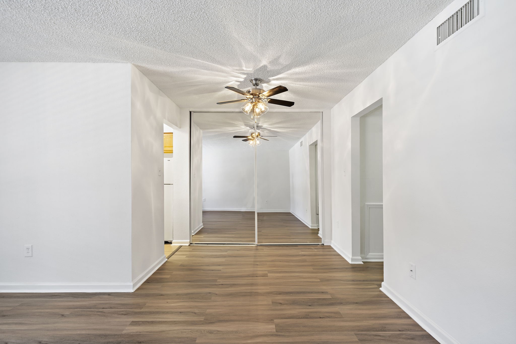 711 Holiday Drive, Unit 33 Galveston, TX 77550 - Photo 3 of 10 a view of an empty room with wooden floor