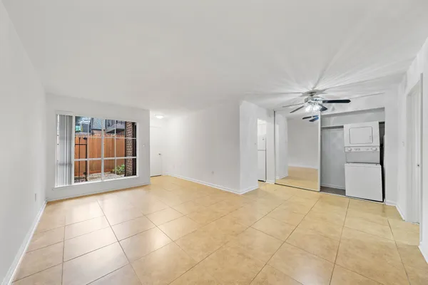 a view of an empty room with a ceiling fan