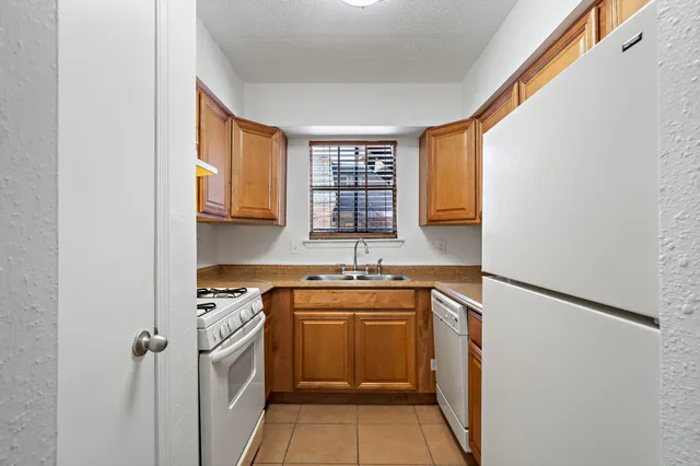 a kitchen with a sink stove and refrigerator