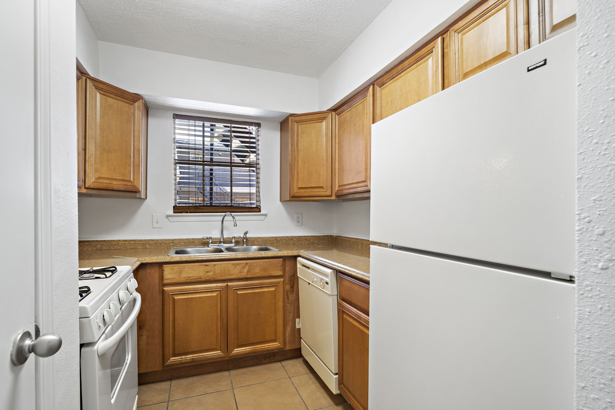 711 Holiday Drive, Unit 33 Galveston, TX 77550 - Photo 5 of 10 a kitchen with a sink stove and cabinets