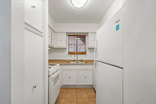 a room with a sink a washer and dryer