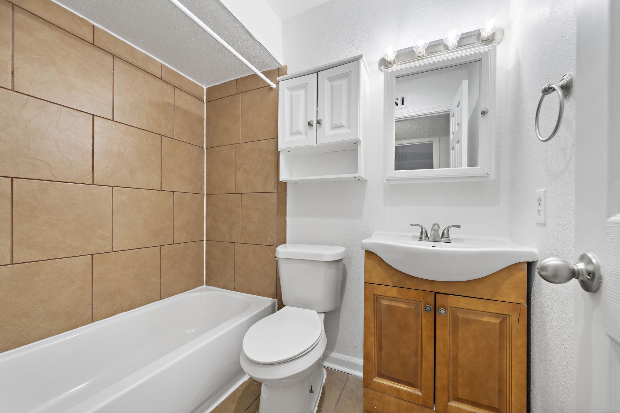 711 Holiday Drive, Unit 33 Galveston, TX 77550 - Photo 7 of 10 a bathroom with a sink toilet and shower