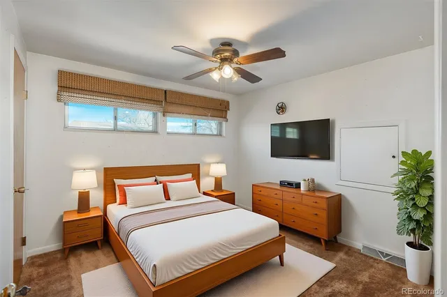 a bedroom with bed and flat screen tv