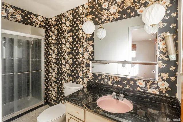 a bathroom with a sink mirror and toilet