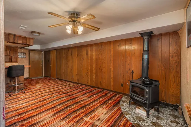 a very nice looking room with wooden floor and furniture