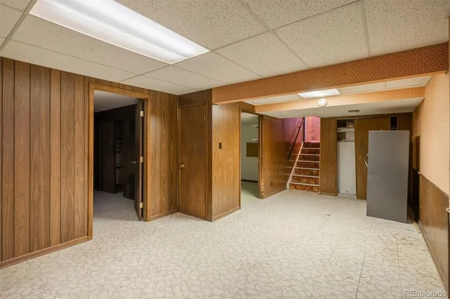 a view of an empty room with closet and a window
