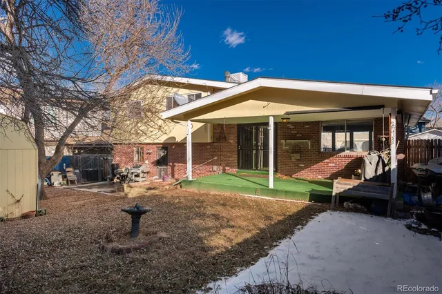 a view of a house with backyard porch and sitting area