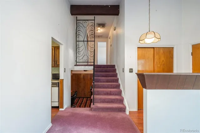 a view of a hallway with wooden floor and entryway