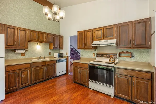 a kitchen with a stove sink and cabinets