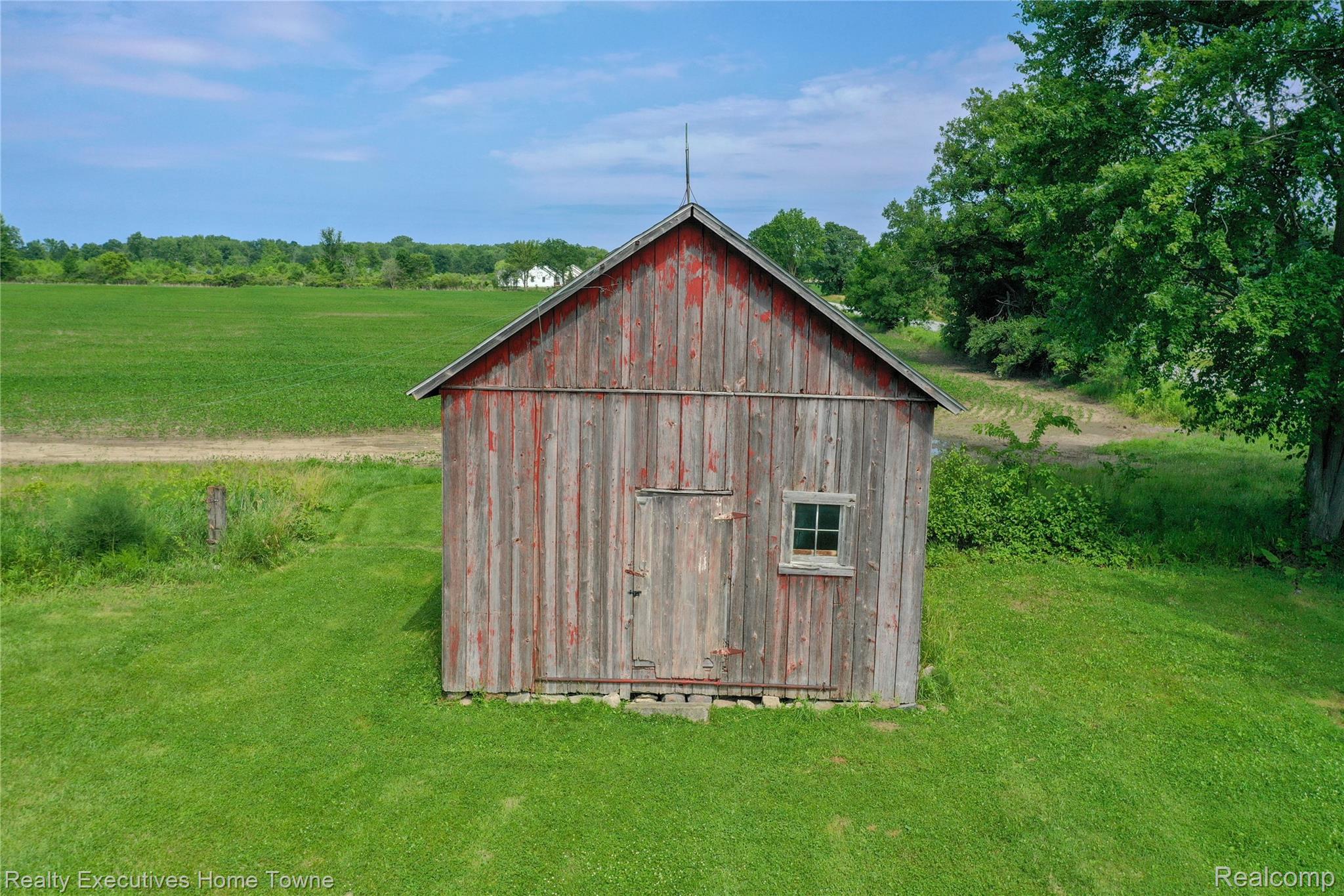 8728 Rynn Road Avoca, MI 48006 - Photo 46 of 53 Rustic wood-sided outbuilding featuring a pitched roof and a small multi-pane window