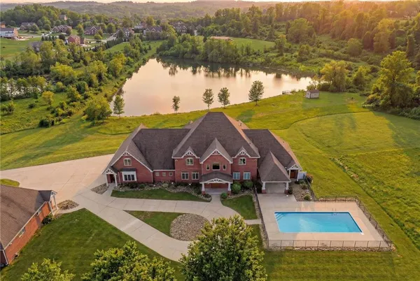 an aerial view of residential houses with outdoor space and swimming pool