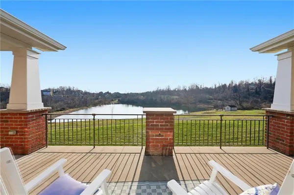 a dining room with furniture wooden floor kitchen view and a chandelier