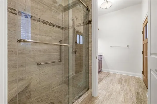 a room with stainless steel appliances a refrigerator and cabinets