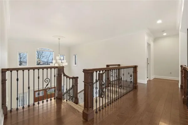 a spacious bedroom with a bed a couch and a large window